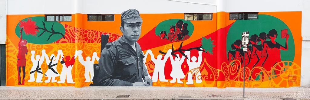 The 2023 version of the urban art mural in  Berna Avenue. It was executed as part of the celebrations of the 50th anniversary of April 25th and the 45th anniversary of the Faculty of Social Sciences and Humanities at the NOVA School of Social Sciences.